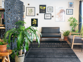 Ivy + Oak Salon waiting room with a collage of botanical prints and hair photos with a variety of plants
