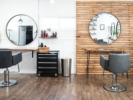 Ivy + Oak salon stations with white and wood walls reflected back in circle mirrors